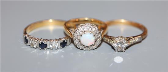 A 18ct and plat, solitaire diamond ring, an 18ct sapphire and diamond ring and a 18ct, white opal and diamond cluster ring.